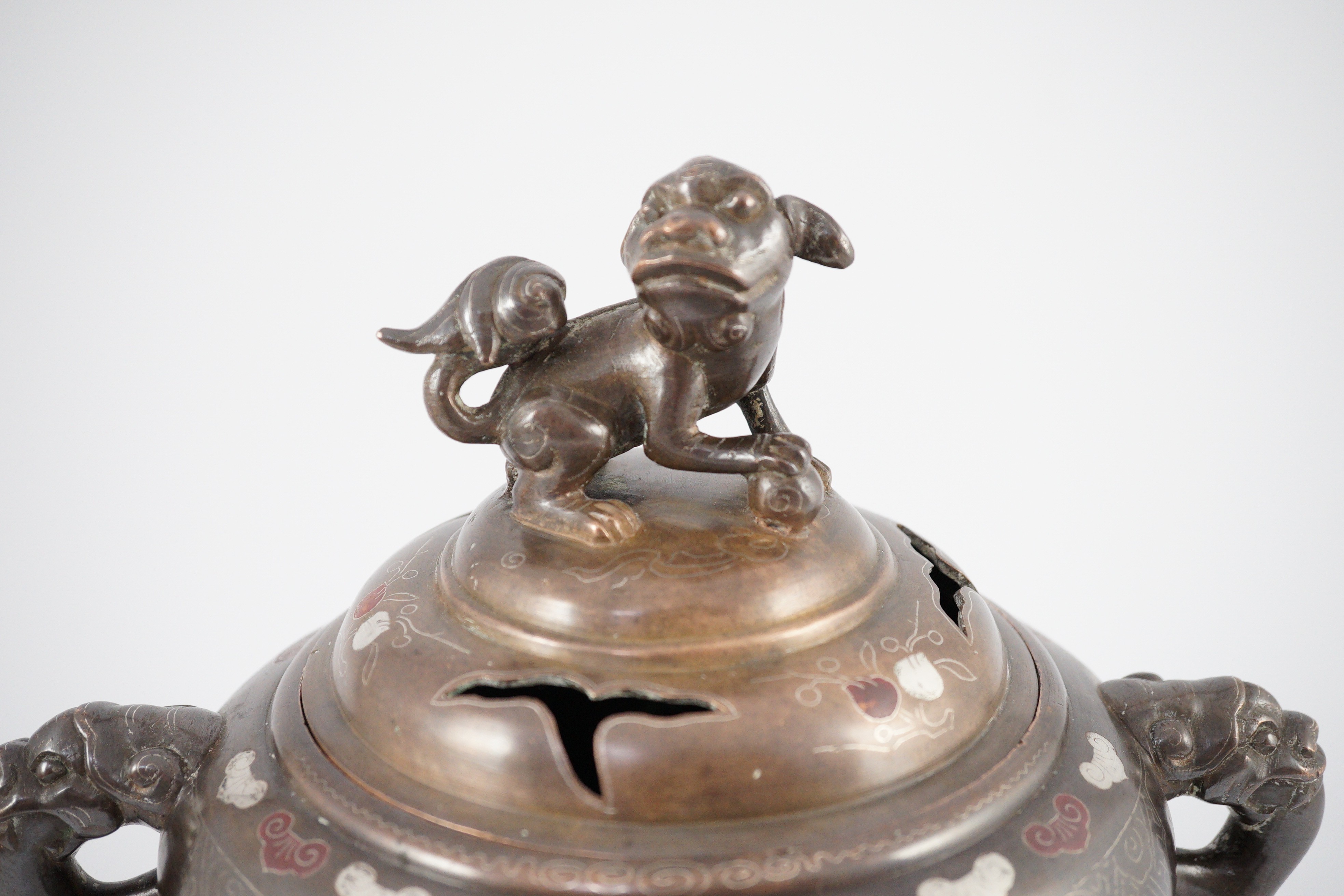 A Vietnamese silver inlaid bronze tripod censer and cover, 19th century, 24cm high, 24cm wide